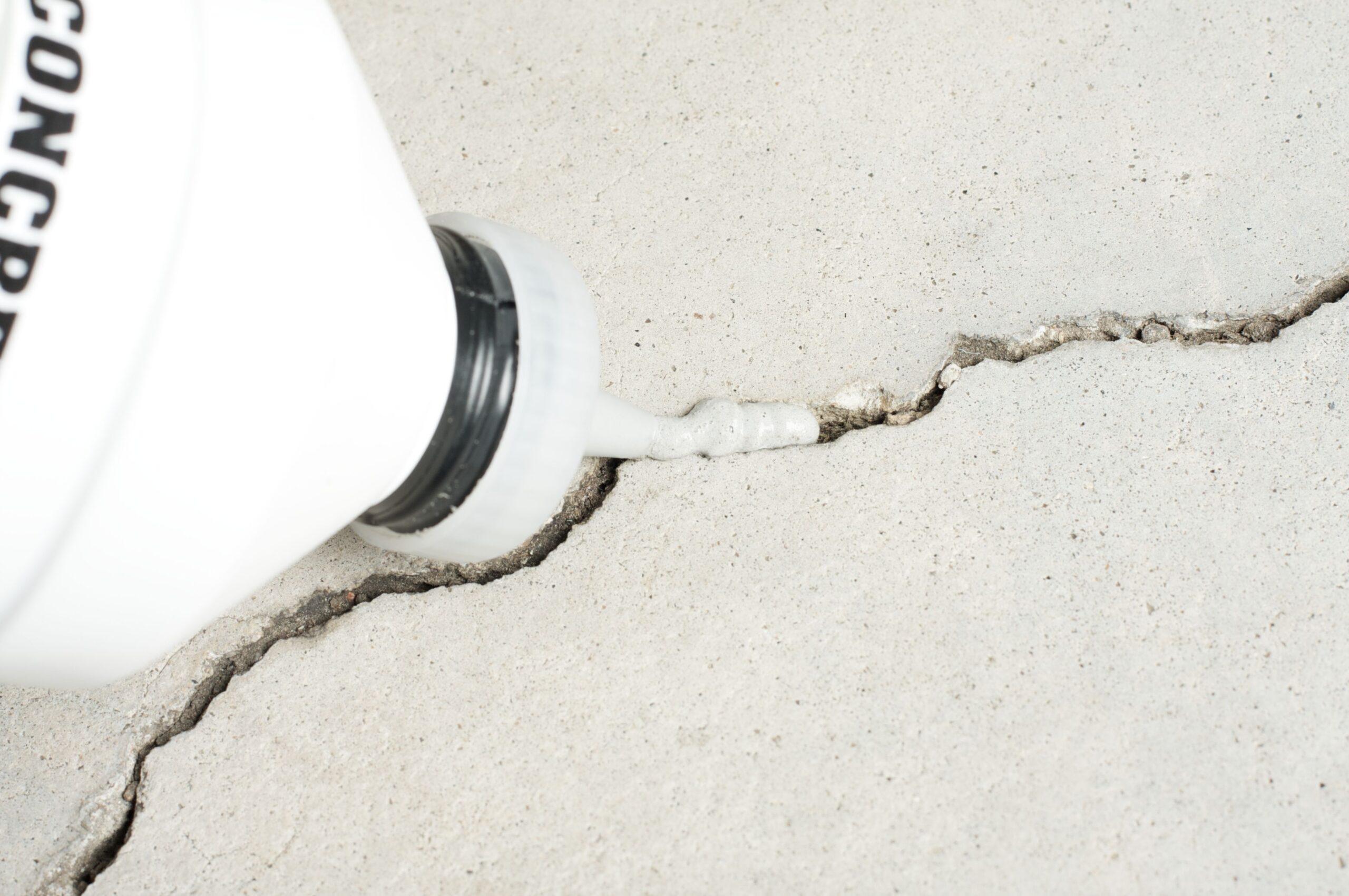 The process of crack repair with concrete.