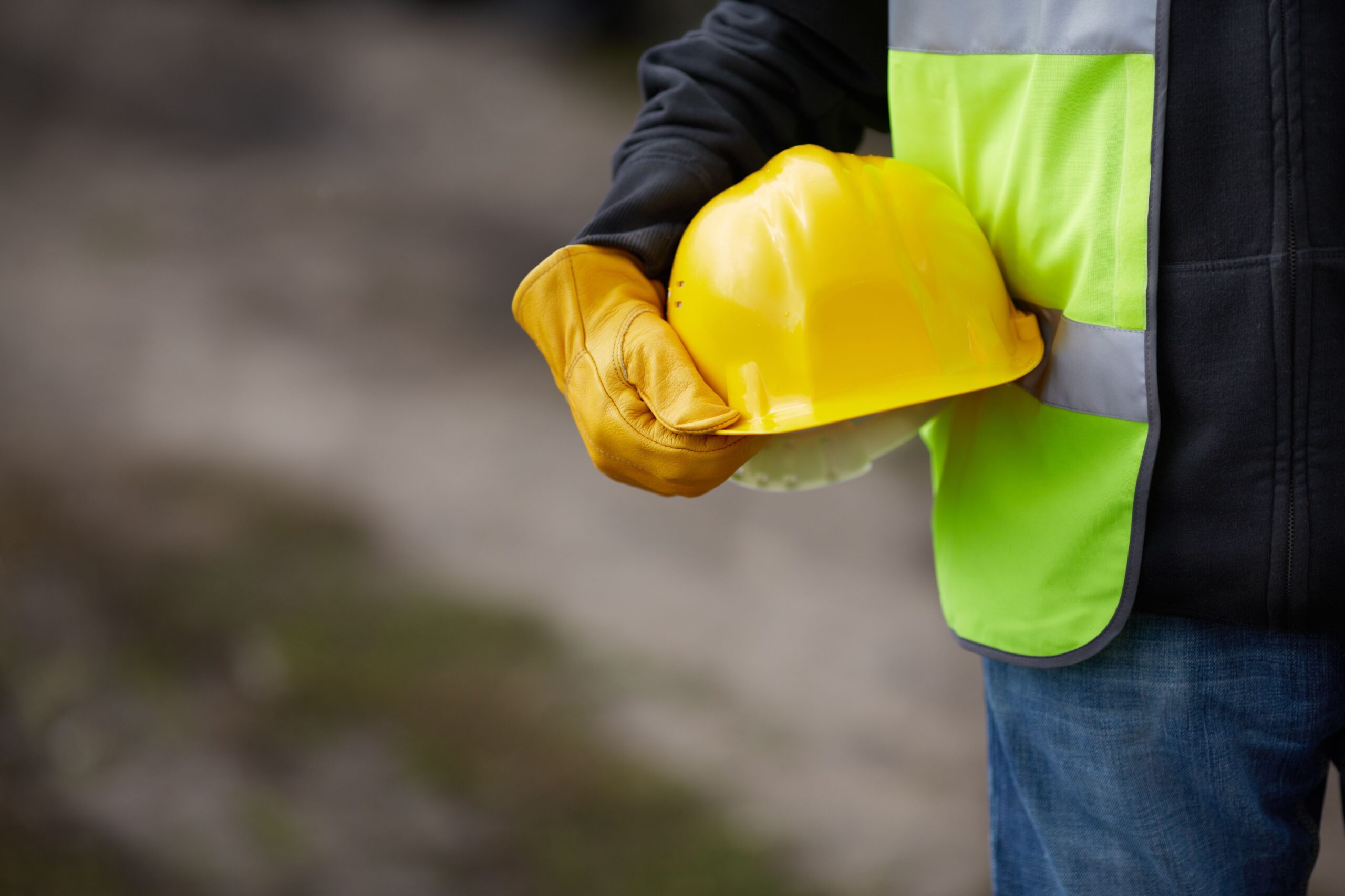 A laborer using proper safety gear for foundation repair.